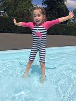 Child enjoying the paddling pool in Tiverton