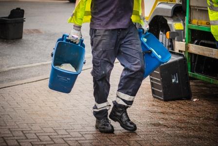 Refuse loader collecting food caddies 