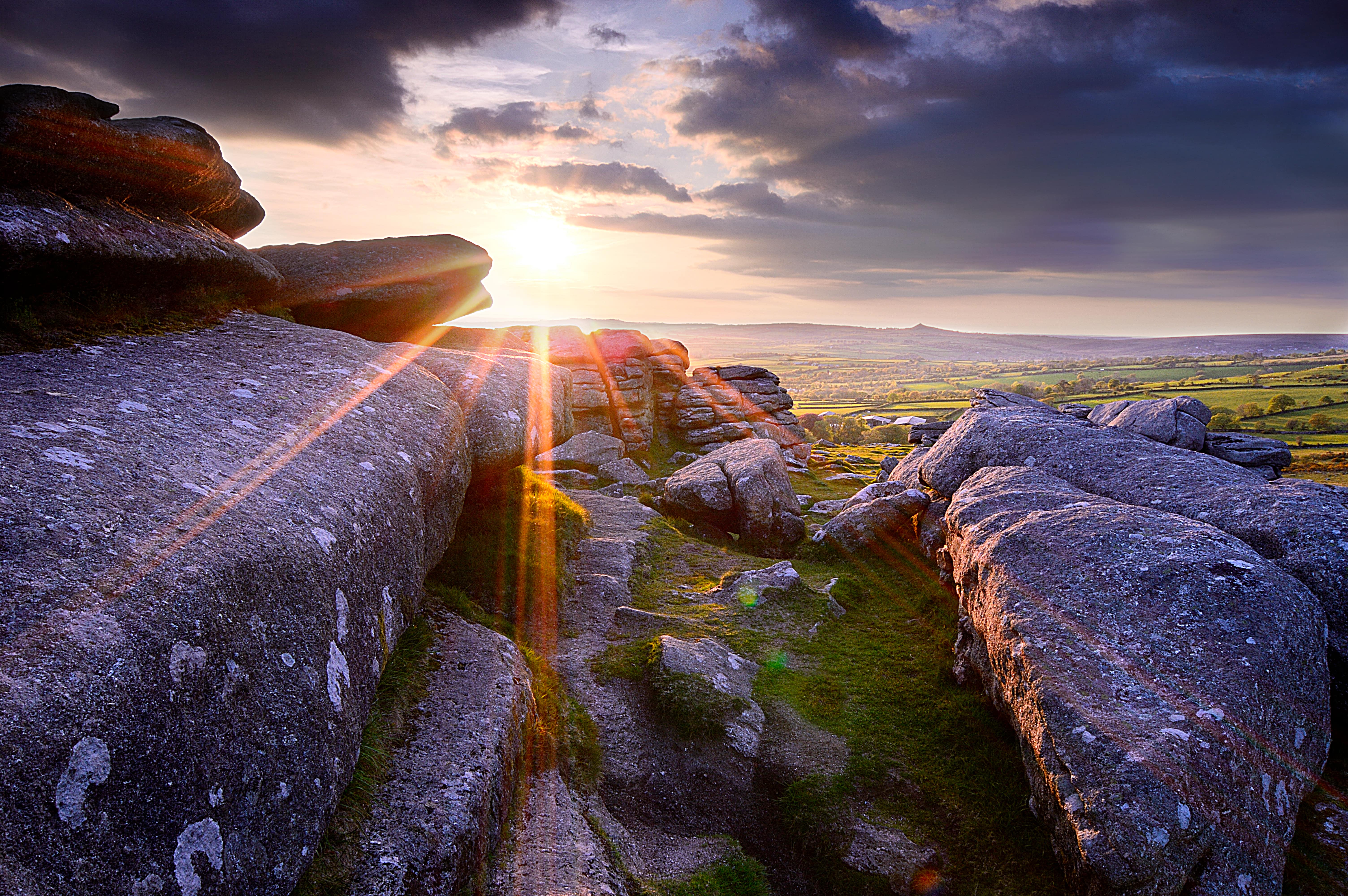 sun shining on a Tor in Dartmoor 