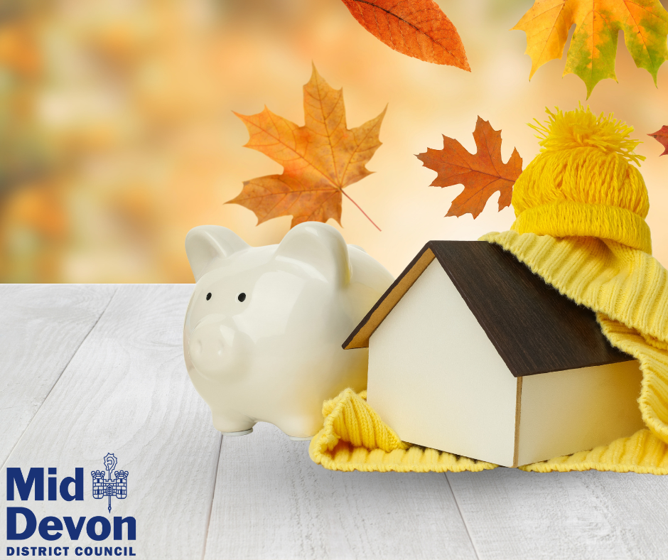 cream piggy bank with pretend house and autumn leaves